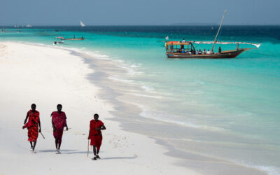 Masai, entertaining tourists on the beach in Nungwi. Zanzibar, Tanzania, East Africa.